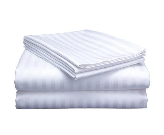 White striped bedsheets on a bed
